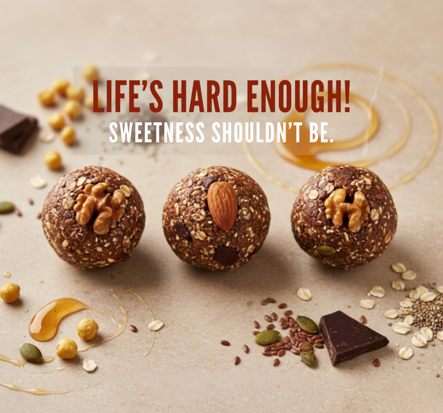 Three raw food balls with nuts and seeds on a textured surface with honey and chocolate pieces.